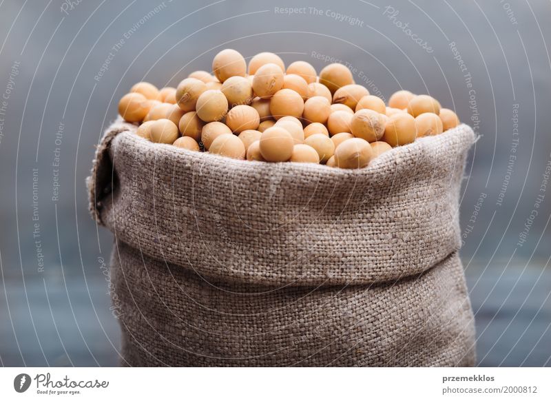Soy beans in a sack on wooden table Grain Nutrition Organic produce Vegetarian diet Asian Food Wood Fresh Healthy Natural Beans Fiber food Ingredients Protein