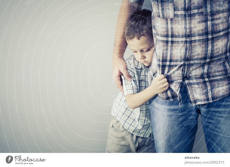 sad son hugging his dad near wall at the day time Face Child Boy (child) Man Adults Parents Father Family & Relations Infancy Sadness Embrace Cry Together