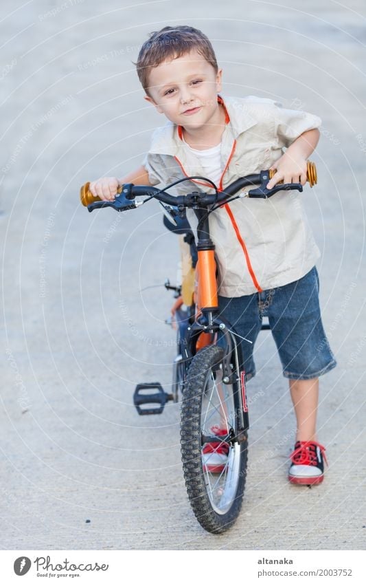 Happy little boy with bicycle standing on road Lifestyle Joy Relaxation Leisure and hobbies Adventure Summer Sports Cycling Child Human being Boy (child) Man