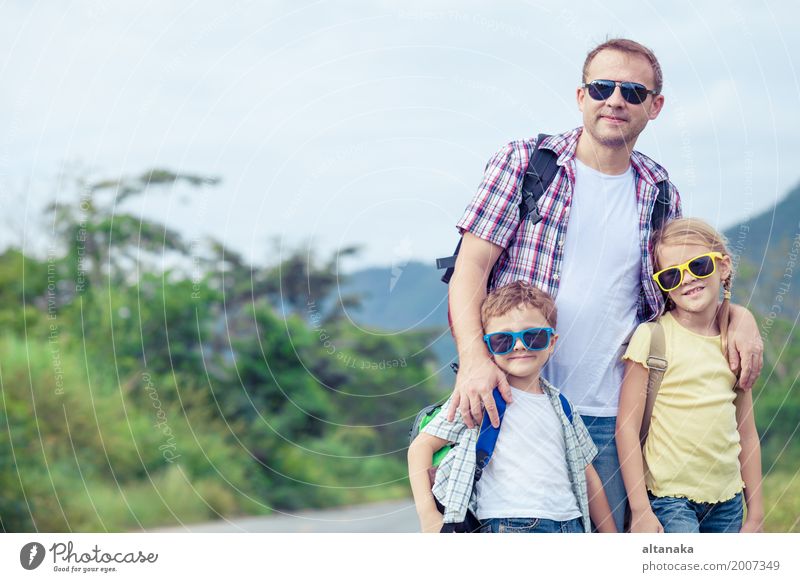 Father and children walking on the road at the day time. Lifestyle Healthy Vacation & Travel Tourism Trip Freedom Summer Hiking Human being Child Parents Adults