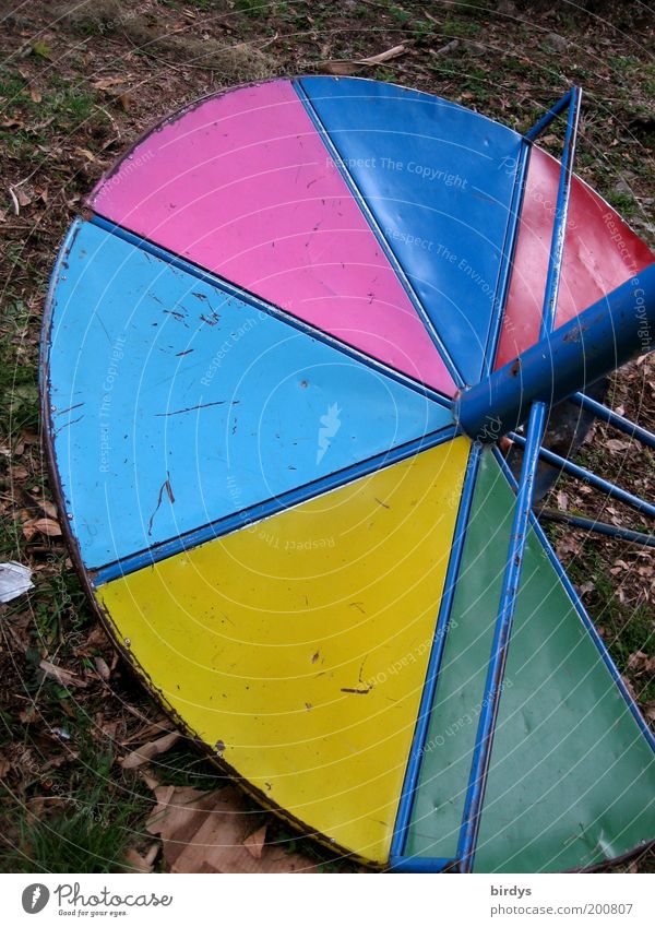 Playful !? Playground Metal Broken Blue Multicoloured Yellow Green Pink Red Transience Contrast Gyroscope Potter's wheel Round Colour photo Exterior shot