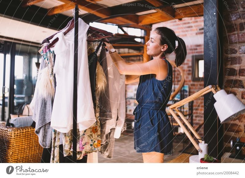 Young woman hanging clothes on coat hanger Lifestyle Style Living or residing Flat (apartment) House (Residential Structure) Living room Work and employment