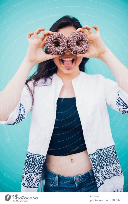 Young woman pulling funny face holding donuts in hands Food Cake Dessert Candy Chocolate Eating Lifestyle Joy Feminine Youth (Young adults) Woman Adults 1