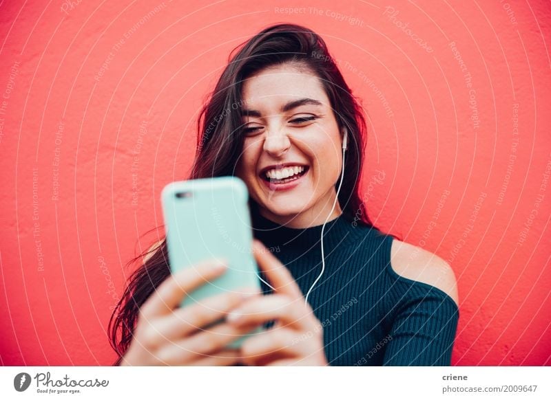 Young happy woman doing video call with smart phone Lifestyle Joy Music To talk Telephone Cellphone Technology Entertainment electronics Telecommunications