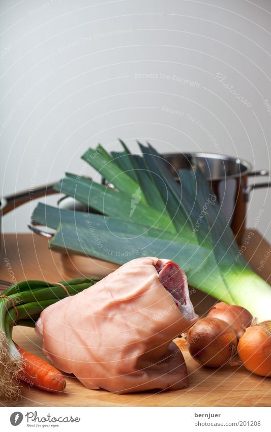 delicious leg knuckle of pork Raw Pork Meat Wood Table Onion Carrot Food Knuckle Kitchen Vegetable Parsley Hide Leek Preparation Fat Deserted Chopping board Pot