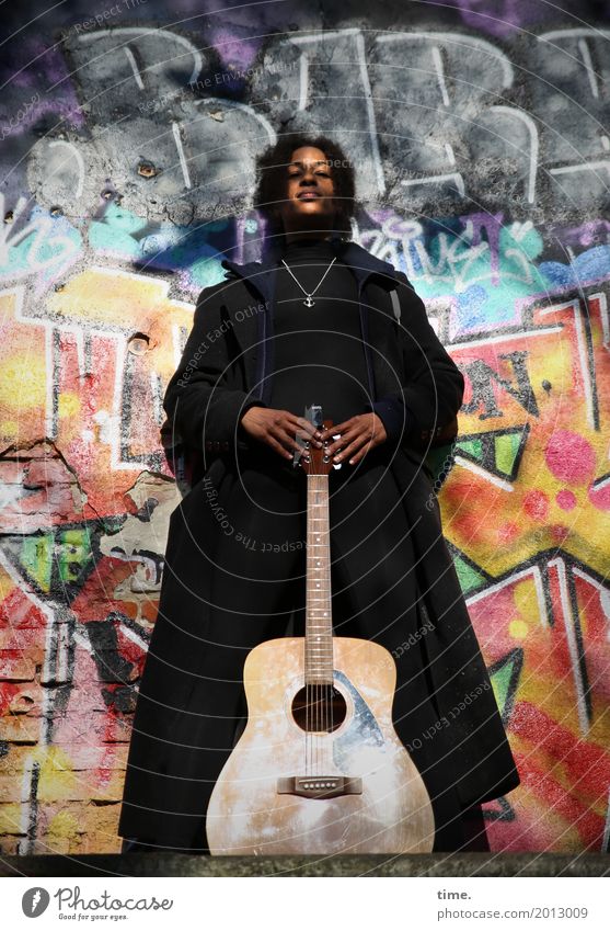 Music Ghetto Priestess Feminine Woman Adults 1 Human being Art Musician Guitar Wall (barrier) Wall (building) Coat Hair and hairstyles Black-haired Long-haired