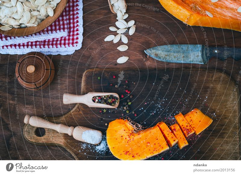 piece of fresh pumpkin with salt and pepper Food Vegetable Herbs and spices Nutrition Knives Spoon Wood Eating Fresh Above Brown Orange White paprika knife cook