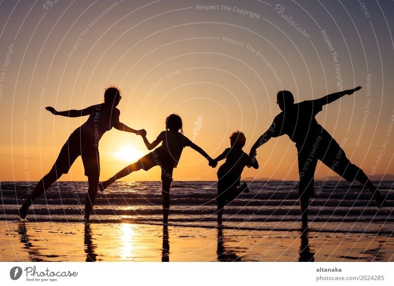 Silhouette of happy family Lifestyle Joy Leisure and hobbies Playing Vacation & Travel Trip Freedom Summer Sun Beach Ocean Sports Child Boy (child) Woman Adults