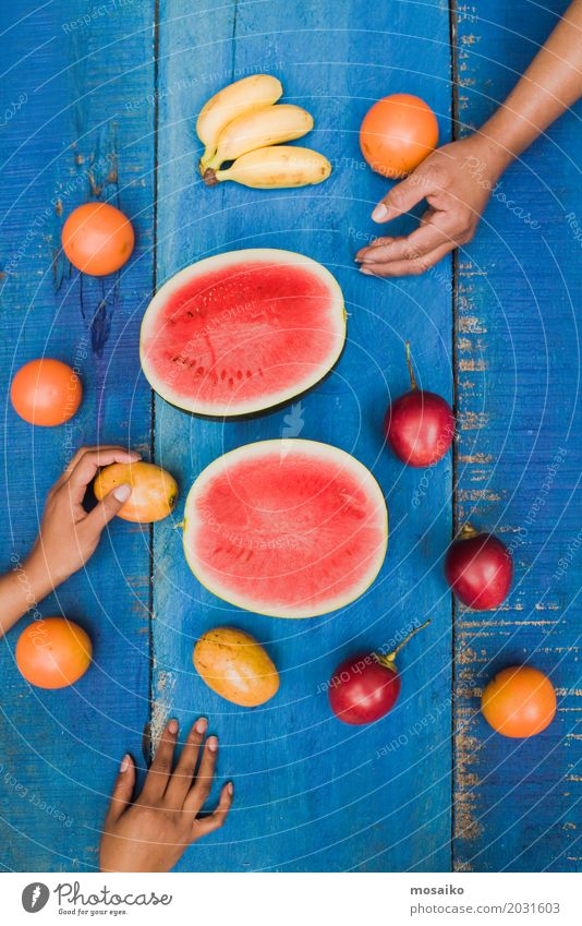 colorful tropical fruits on blue wooden background Fruit Dessert Vegetarian diet Diet Juice Exotic Joy Summer Table Hand Wood Fresh Delicious Natural Juicy Blue