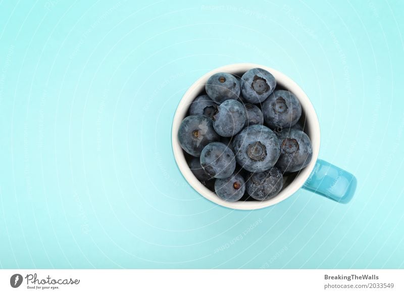 Blueberries in a blue cup, top view Food Fruit Diet Mug Healthy Eating Blueberry Blue background Bird's-eye view Fresh Berries Nutrition Portion Vitamin