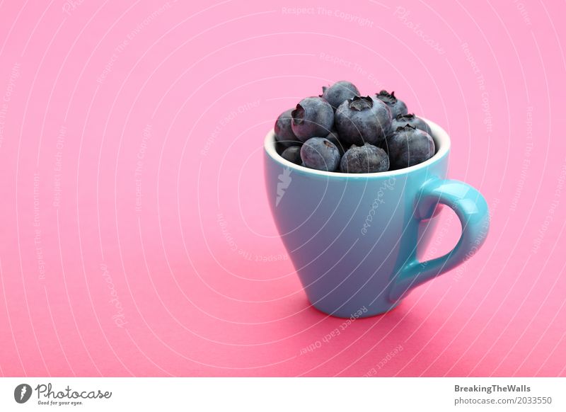 Cup of fresh blueberries over pink paper Food Fruit Nutrition Breakfast Vegetarian diet Diet Mug Healthy Eating Blue Pink Fresh Blueberry Coffee cup Art Full