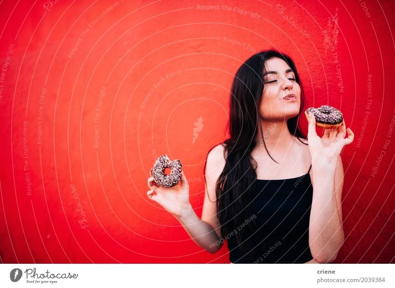 Young happy woman eating chocolate donuts Food Cake Dessert Candy Chocolate Eating Fast food Finger food Lifestyle Joy Human being Feminine Young woman