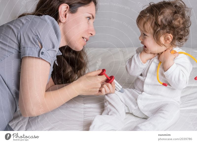 Baby and mom are playing doctor Joy Illness Medication Playing Child Profession Doctor Hospital To talk Toddler Woman Adults Mother Family & Relations Toys