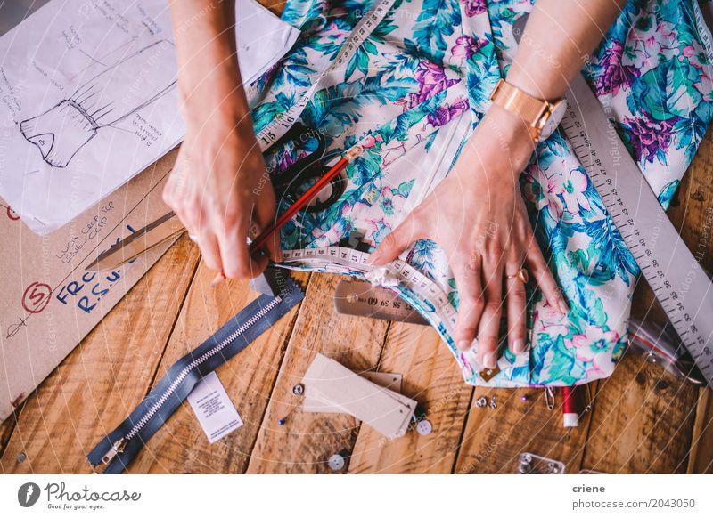 Female Fashion Designer Measuring and Cutting Fabric before Sewing