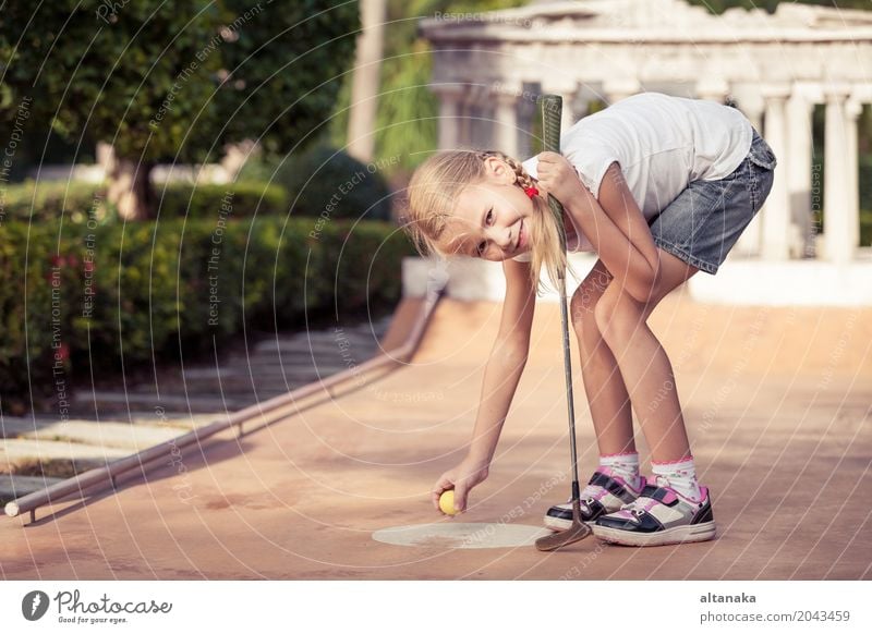 Little girl swinging mini golf club Lifestyle Joy Happy Face Relaxation Leisure and hobbies Playing Vacation & Travel Freedom Summer Club Disco Sports Golf