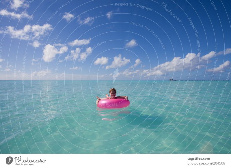 POINT PINK Pink Water wings Sky Turquoise Ocean Horizon Colour photo Copy Space top Copy Space bottom Woman Float in the water Leave Vacation & Travel