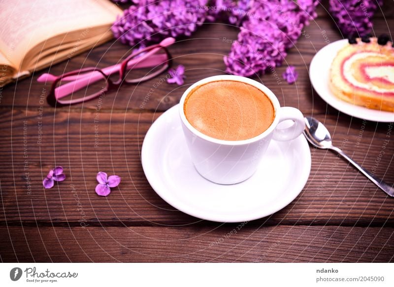 Espresso in a white cup with a saucer Breakfast To have a coffee Hot drink Coffee Mug Restaurant Book Flower Bouquet Wood Eating To enjoy Above Retro Brown