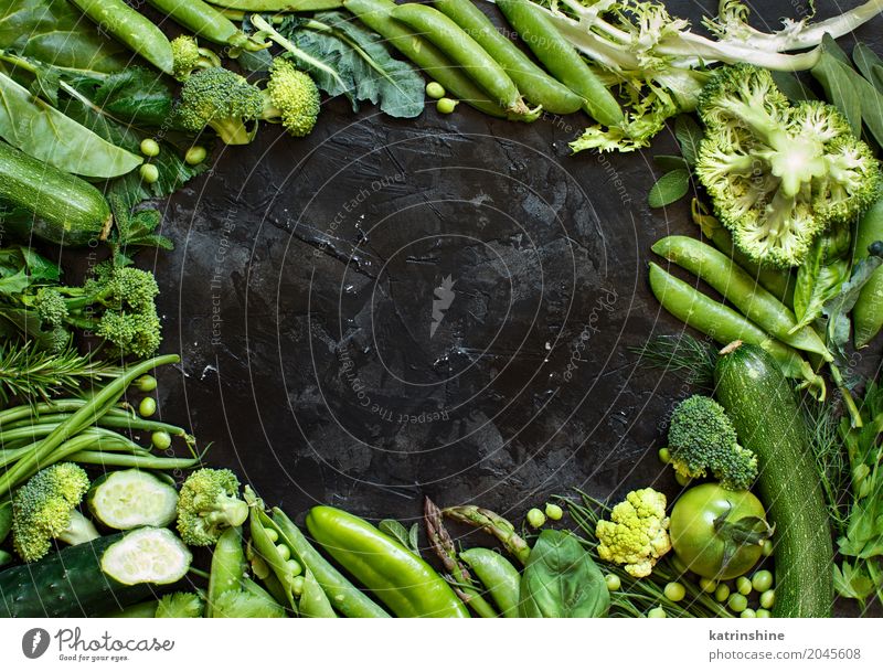 Mix of green vegetables on a dark table close up Vegetable Herbs and spices Diet Leaf Fresh Green agriculture Asparagus Beans bio Broccoli dieting Farm food