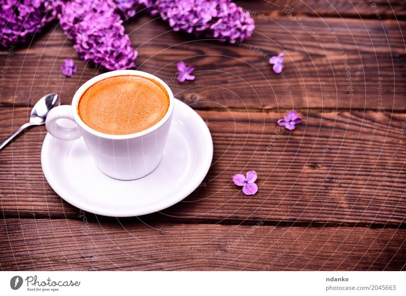 Espresso coffee in a white small cup Breakfast Coffee Spoon Table Restaurant Flower Bouquet Wood Fresh Hot Above Retro Brown Black White Purple Café drink
