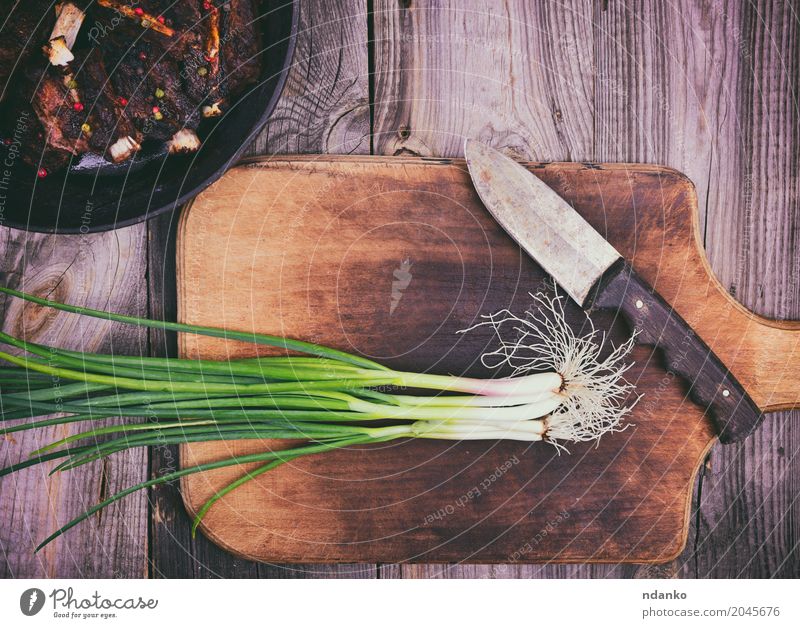 Green onion on a kitchen cutting board Meat Vegetable Pan Knives Kitchen Wood Eating Fresh Above Onion frying pan Top knife vintage food Salad healthy