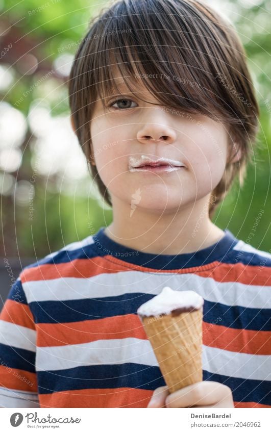 A boy with an ice-cream cone and a beard of ice-cream Food Ice cream Nutrition Picnic Shopping Happy Well-being Contentment Vacation & Travel Summer Sun