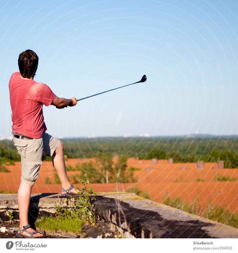 Golfing above the roofs II Leisure and hobbies Summer Sports Ball sports Success Masculine Young man Youth (Young adults) Factory Ruin Roof Athletic Effort