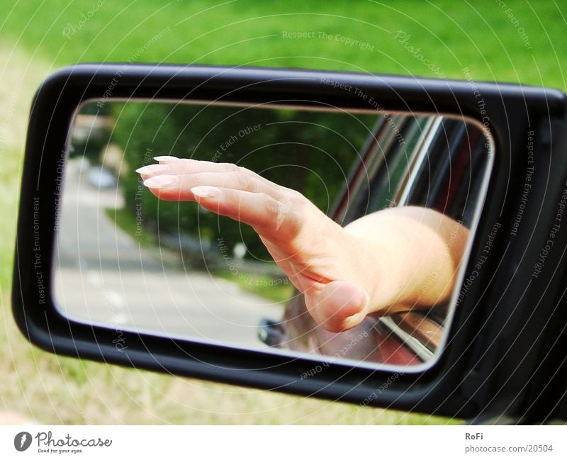 Hand in rearview mirror Rear view mirror Driving Transport Fingers Mirror Car Street Sun Beautiful weather