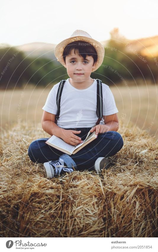 Boy reading a book Lifestyle Leisure and hobbies Reading Vacation & Travel Adventure Education Schoolchild Student Human being Masculine Child Toddler