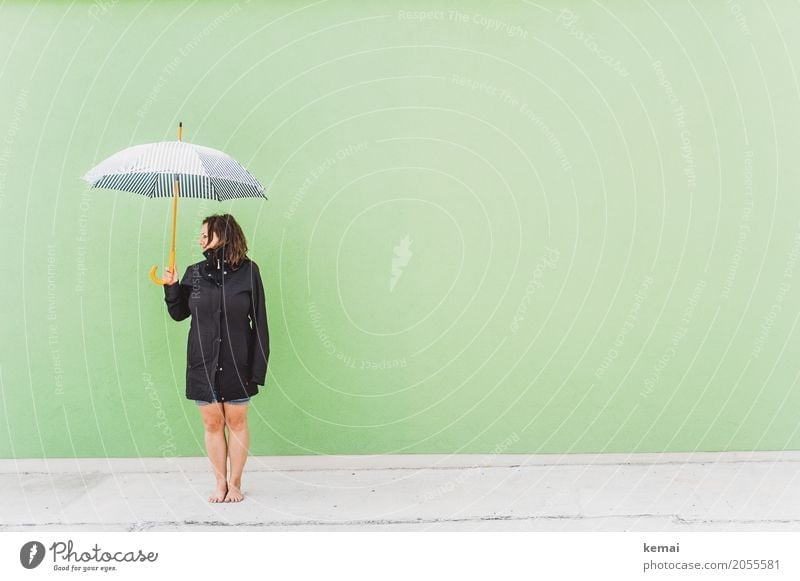 Woman with umbrella in front of green wall Lifestyle Style Harmonious Well-being Contentment Relaxation Calm Leisure and hobbies Vacation & Travel Trip