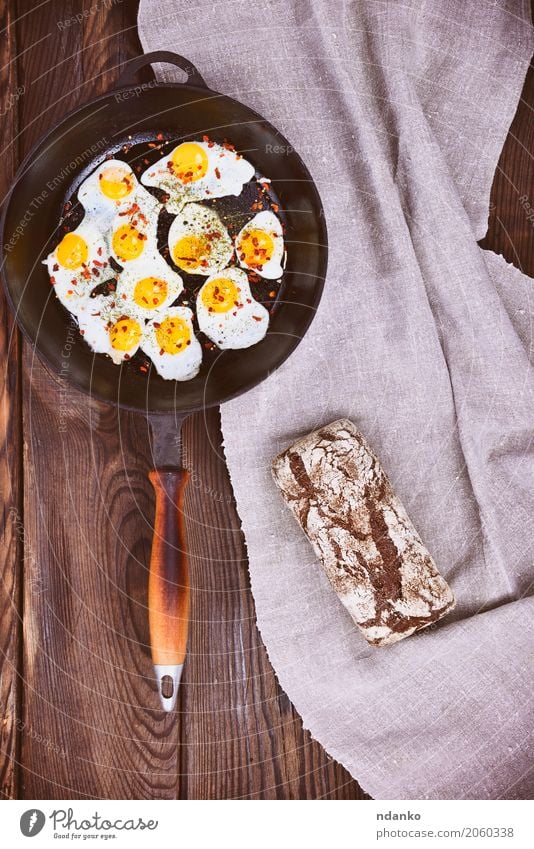Fried quail eggs in a frying pan Food Bread Eating Breakfast Pan Kitchen Natural Above Retro Brown Yellow Egg Yolk Protein Frying cook vintage Top Dish Meal