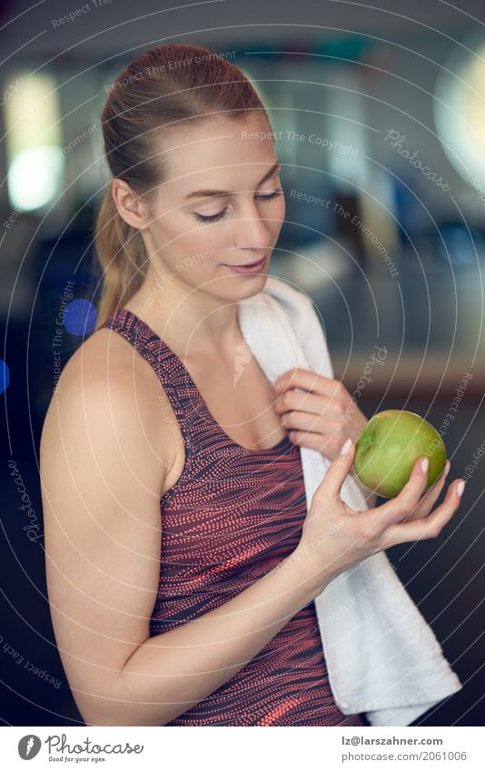 Fit sporty young woman contemplating an apple Fruit Diet Lifestyle Skin Sports Woman Adults 1 Human being 18 - 30 years Youth (Young adults) Blonde Athletic