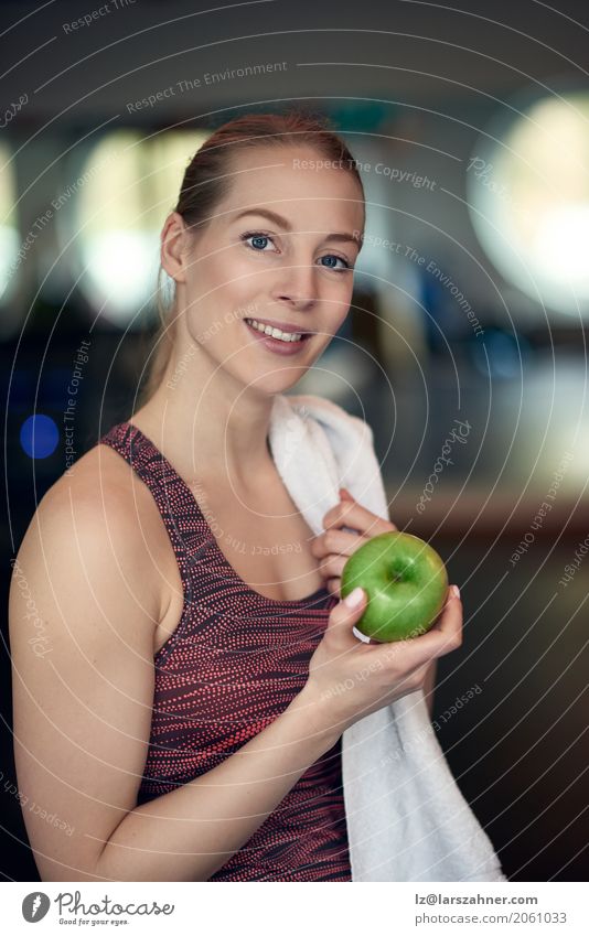 Attractive young woman athlete holding an apple Fruit Diet Lifestyle Sports Woman Adults 1 Human being 18 - 30 years Youth (Young adults) Athletic Fresh Natural