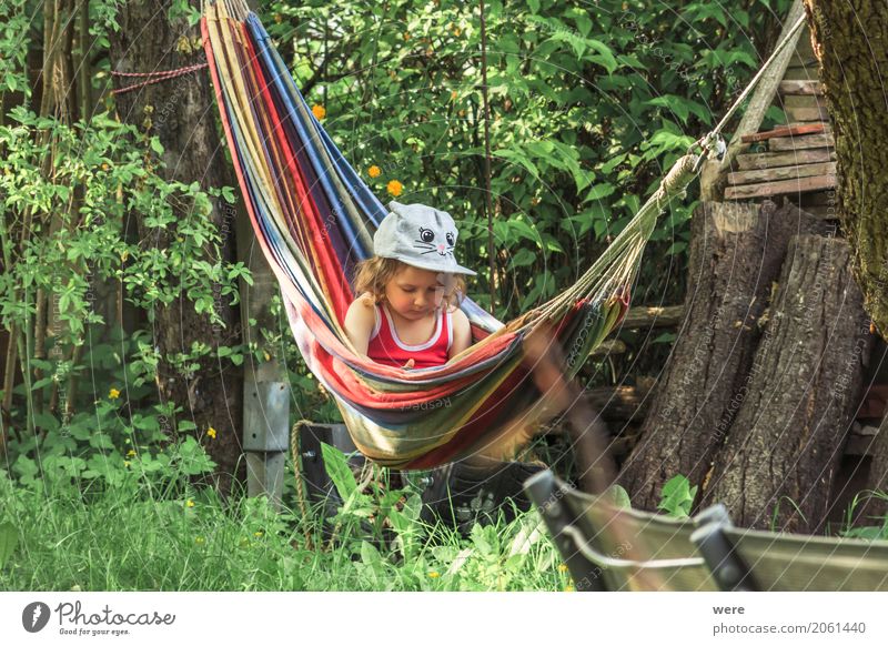 A toddler sits in a hammock in the garden Contentment Relaxation Calm Human being Feminine Child Girl Infancy 1 1 - 3 years Toddler Environment Nature