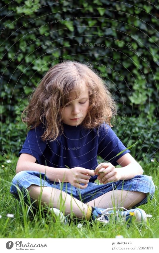 Portrait of a lonely boy , dreamy, sitting on the meadow Child Boy (child) Infancy 1 Human being 8 - 13 years T-shirt Jeans Shorts Long-haired Curl Think