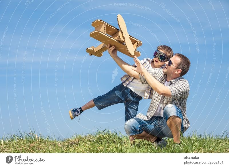 Father and son playing with cardboard toy airplane Lifestyle Joy Happy Leisure and hobbies Playing Vacation & Travel Adventure Freedom Summer Sports Child