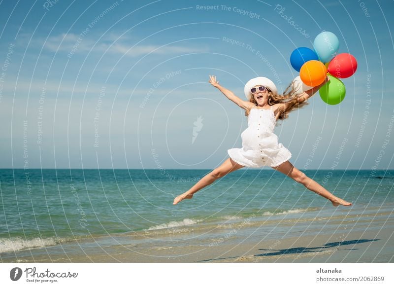 Teen girl with balloons jumping on the beach Lifestyle Joy Happy Relaxation Leisure and hobbies Playing Vacation & Travel Trip Adventure Freedom Summer Sun