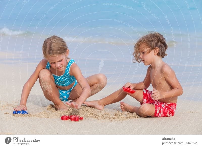 Two happy children playing on the beach Lifestyle Joy Happy Beautiful Relaxation Leisure and hobbies Playing Vacation & Travel Freedom Summer Sun Beach Ocean