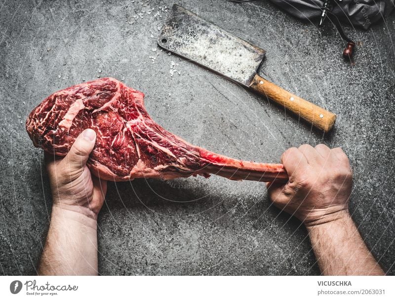 Tomahawk beef steak in male hands with meat chopper Food Meat Style Table Kitchen Restaurant Masculine Hand Barbecue (apparatus) Concrete Design Steak Man Stop