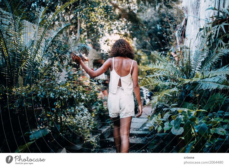 Back view of Afro American woman in tropical garden Beautiful Adventure Summer Garden Human being Feminine Young woman Youth (Young adults) Nature Plant Warmth