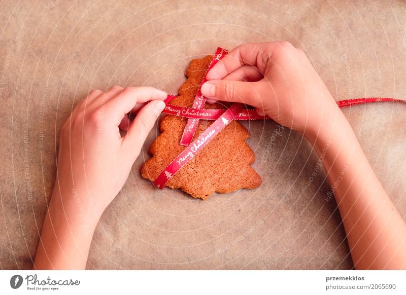 Female hands tying baked Christmas gingerbread with ribbon Food Candy Lifestyle Decoration Feasts & Celebrations Christmas & Advent Human being Girl Hand
