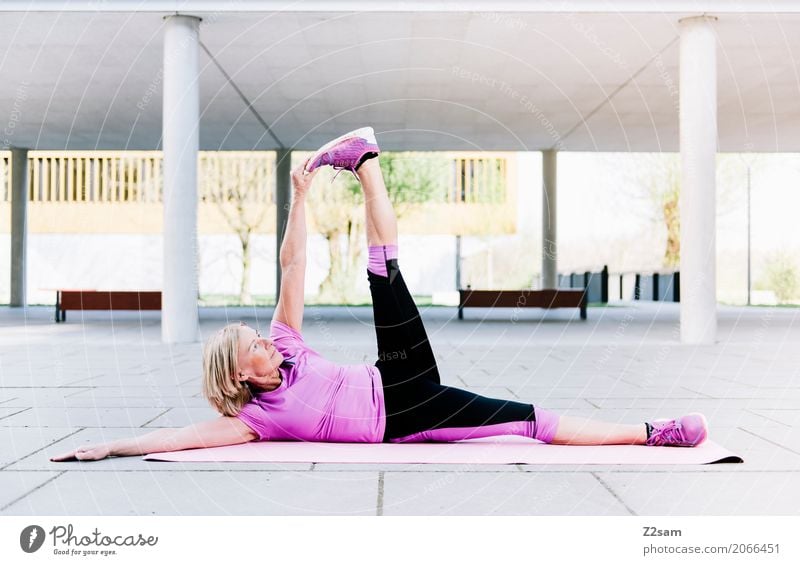 high the leg Lifestyle Leisure and hobbies Fitness Sports Training Yoga Woman Adults Female senior 45 - 60 years Town Sneakers Blonde Relaxation Smiling Lie