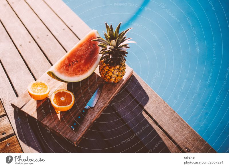 Plate with Tropical fruits next to swimming pool Food Fruit Orange Nutrition Eating Lifestyle Swimming pool Swimming & Bathing Leisure and hobbies Summer