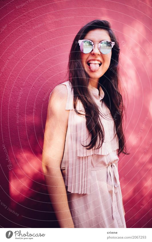 Happy young woman stretching out her tongue Lifestyle Joy Human being Feminine Young woman Youth (Young adults) Woman Adults 1 18 - 30 years Sunglasses Brunette