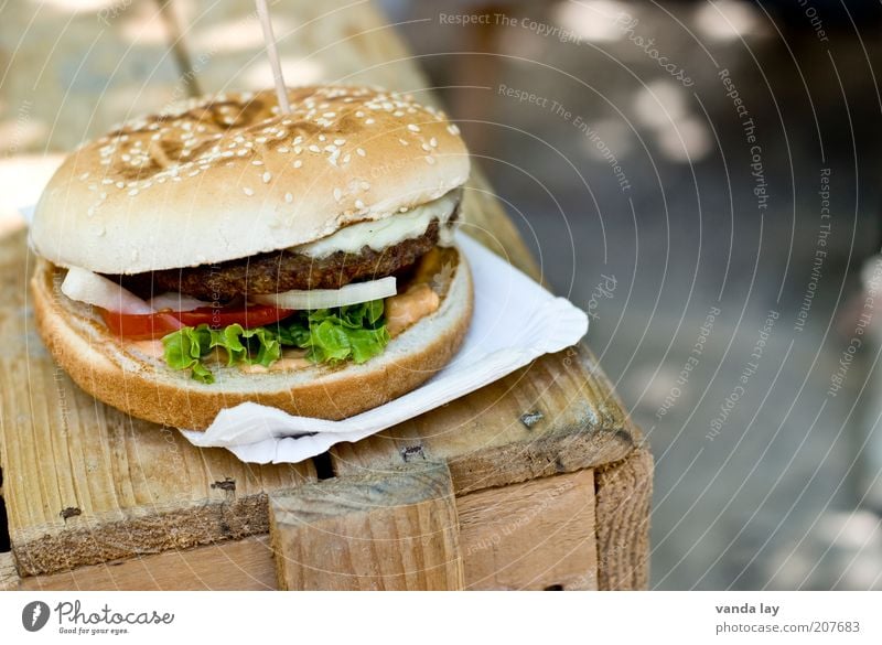burgers Food Meat Roll Nutrition Fast food Finger food Fat Vice Unhealthy Hamburger Wood Table Onion Lettuce Tomato Rich in calories paper plates Colour photo