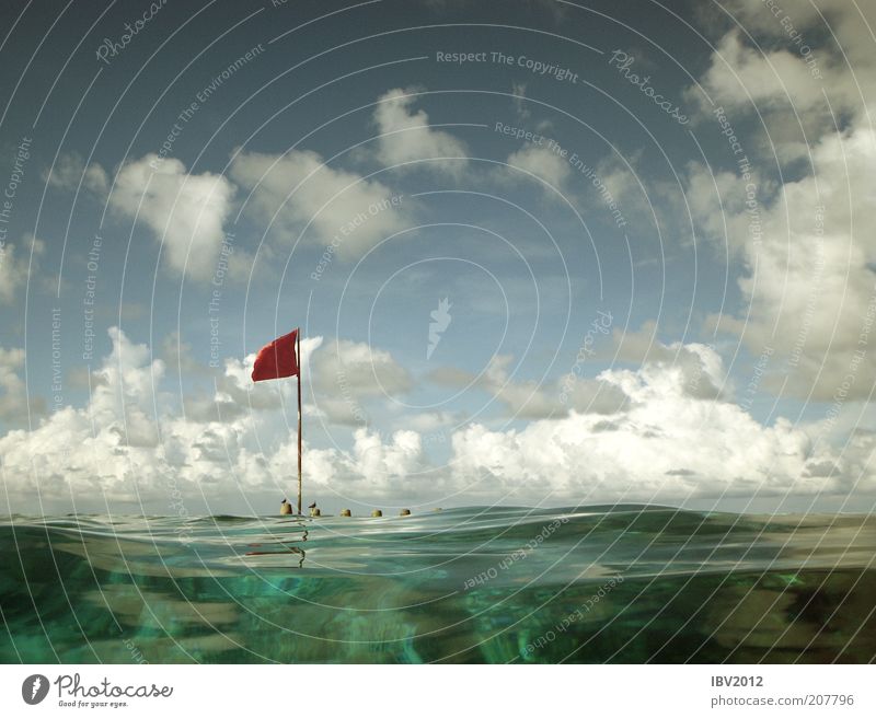 Red flag in paradise IV Summer Summer vacation Ocean Island Waves Coral reef Leisure and hobbies Maldives Asia Flag Clouds Sky Indian Ocean Vacation & Travel