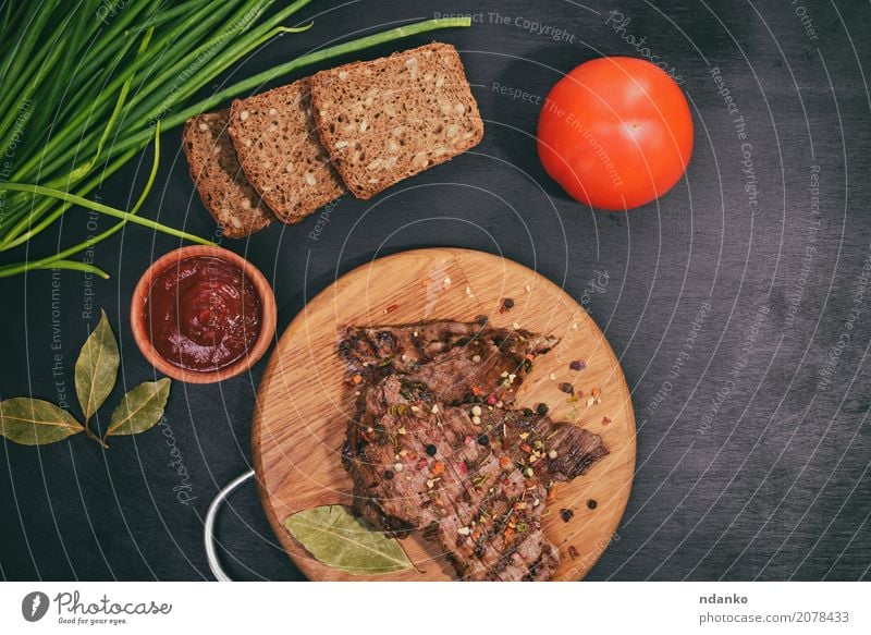 Grilled beef on a wooden board Meat Vegetable Bread Herbs and spices Nutrition Lunch Dinner Table Kitchen Wood Eating Fresh Above Green Red Black Onion Dish