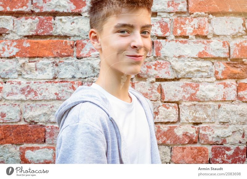 Portrait in front of brick wall Lifestyle Style Beautiful Contentment Senses Human being Masculine Young man Youth (Young adults) 1 13 - 18 years Wall (barrier)