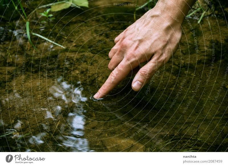 Hand touching fresh fountain water Human being Masculine Young man Youth (Young adults) Fingers Environment Nature Elements Water Spring Summer Lakeside Touch