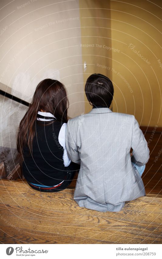 sit in Flirt Masculine Couple 2 Human being Stairs Suit Black-haired Brunette Sit Agreed Attachment Together Staircase (Hallway) Side by side Back Interior shot