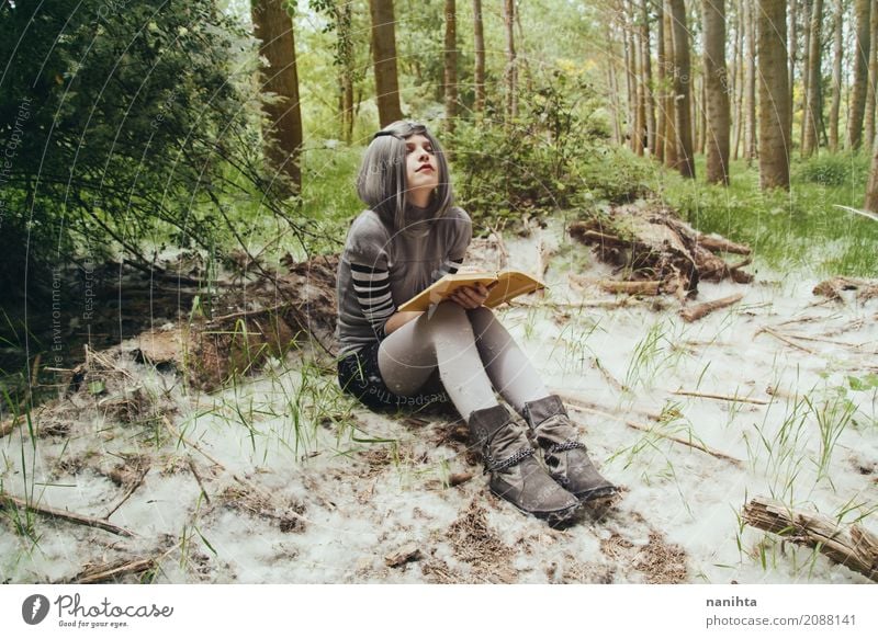 Young woman with a book in a forest Lifestyle Relaxation Reading Human being Feminine Youth (Young adults) 1 18 - 30 years Adults Environment Nature Landscape